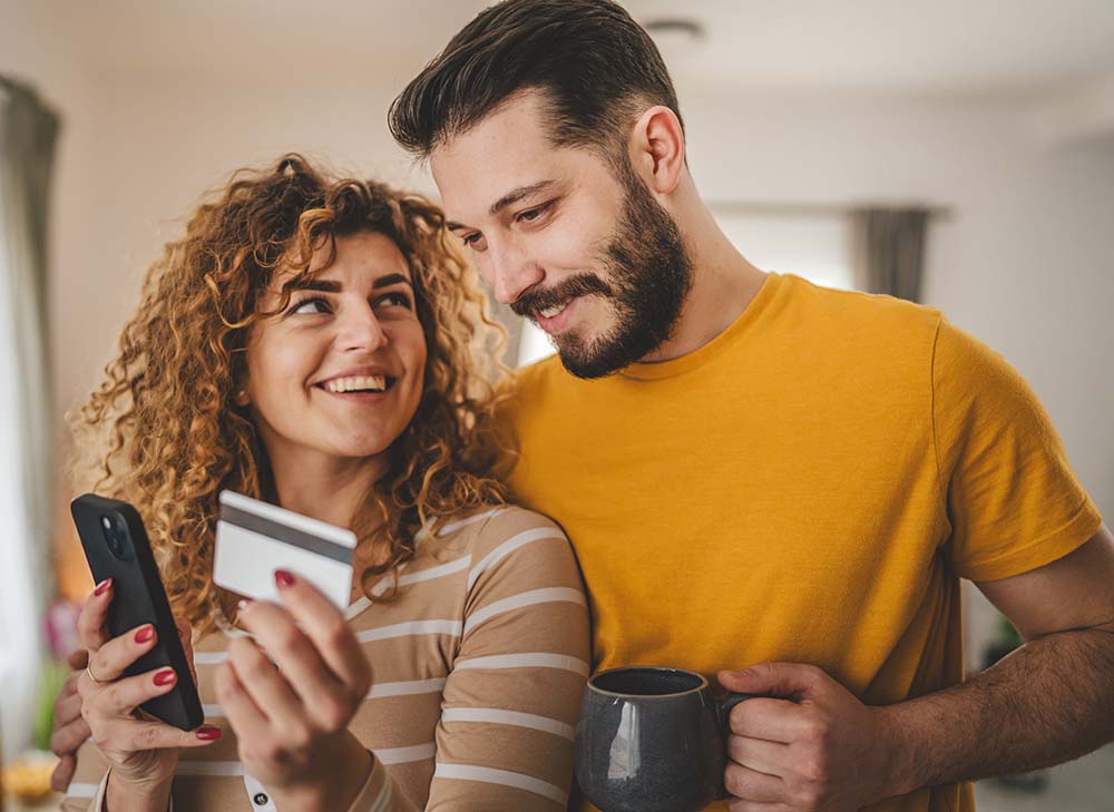 GCCU Visa Credit Cards - Happy Couple Checking Their Card Balance